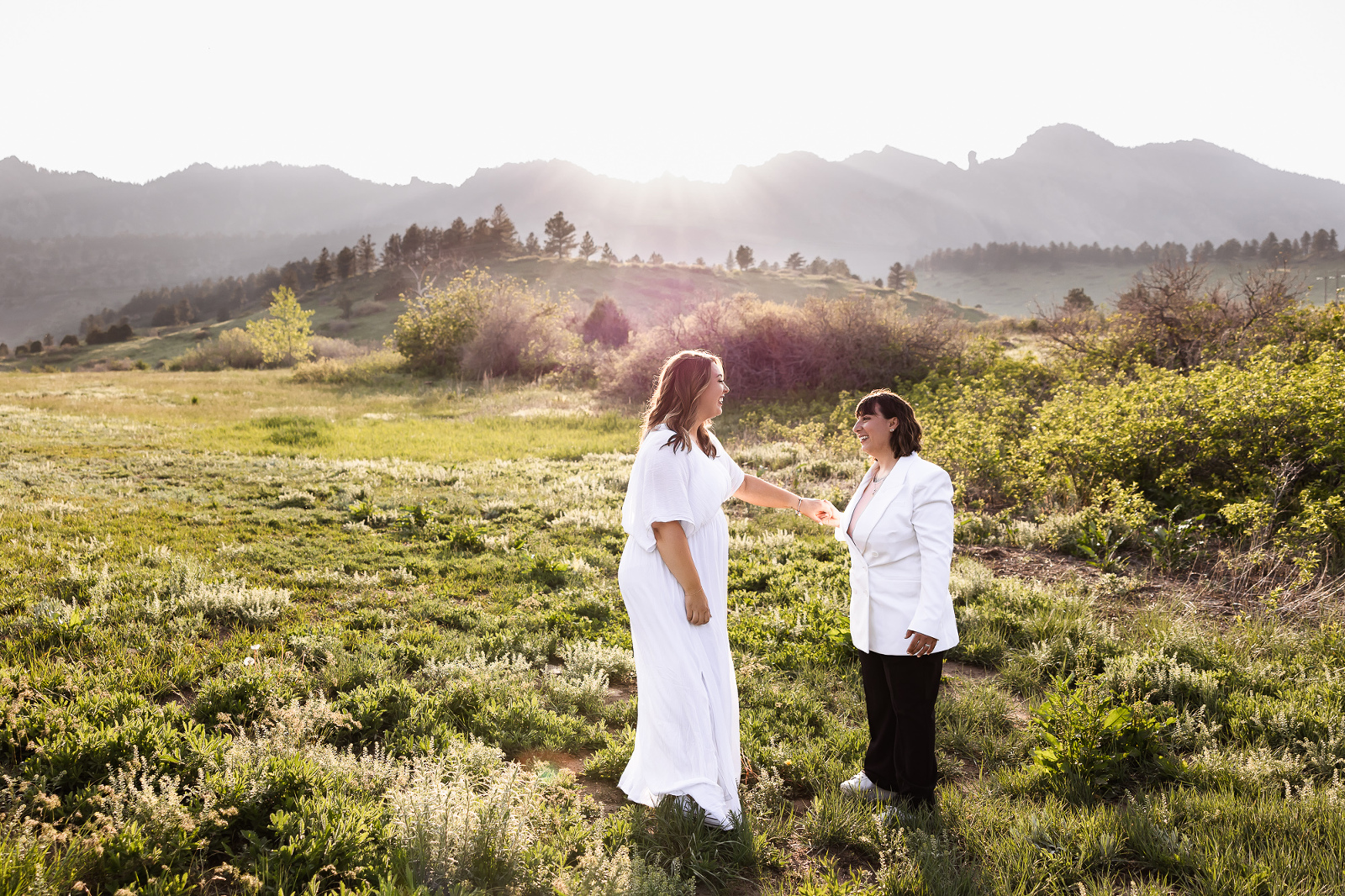 Boulder Elopement Photographer with two brides dancing in the sunlight