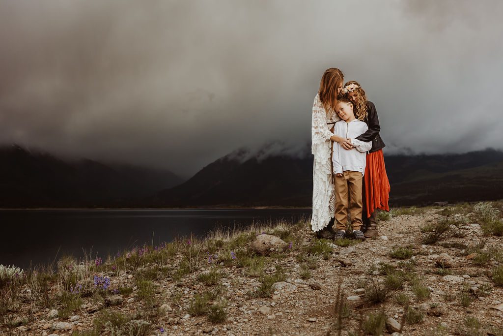 Photographer Kristin Christian snuggling her kids on a stormy afternoon at Twin Lakes in Aspen, Colorado.