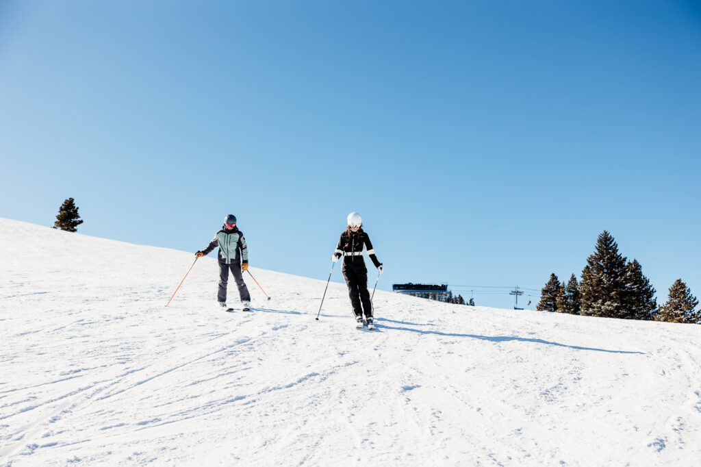 Couple skiing at Vail after a skiing surprise proposal at the top of the Avanti Lift with Colorado Lifestyle Photography