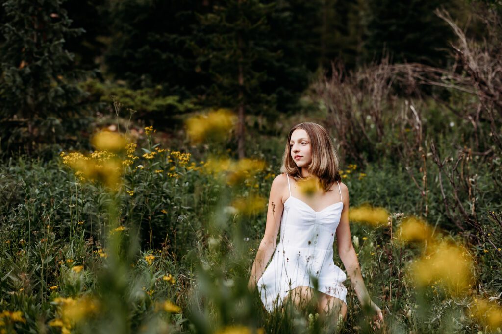 Senior pictures in wildflowers at Boreas Pass in Breckenridge Colorado
